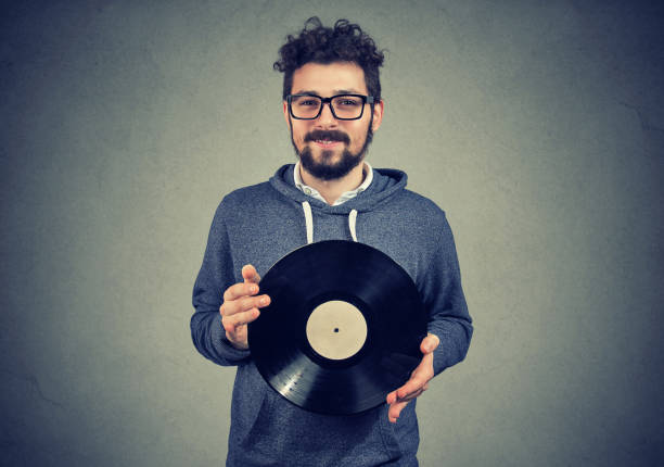 Happy hipster man with vinyl disk
