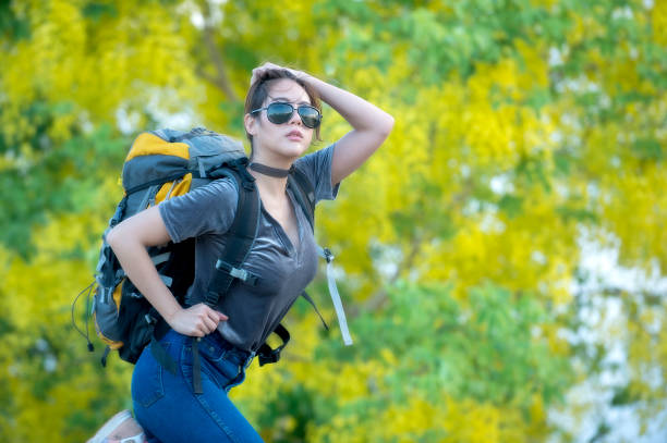 A beautiful backpacker woman traveler alone Travel Lifestyle find freedom. Concept adventure vacation outdoor.