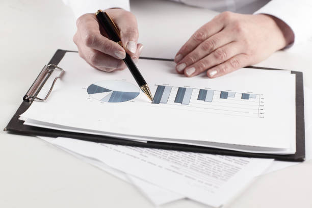istock closeup.business woman analyzing marketing graphics 969133286