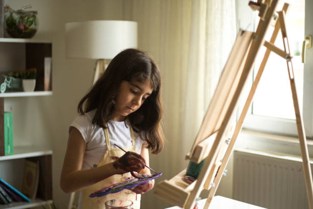 istock Young Girl Painting 969133296
