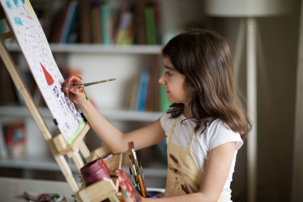 istock Young Girl Painting 969136502