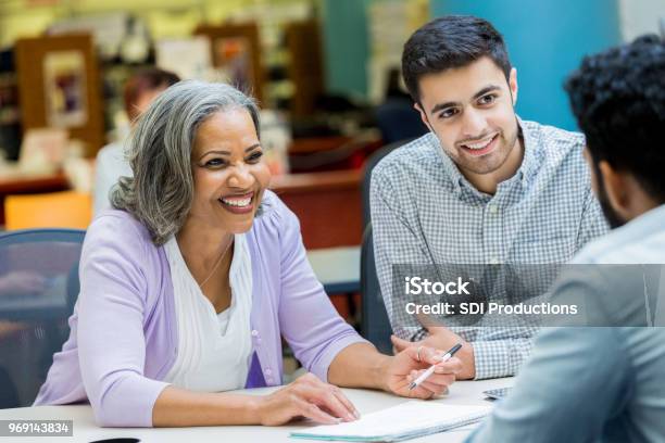 Senior Manager Facilitates Staff Meeting Stock Photo - Download Image Now - Education, Leadership, Senior Adult