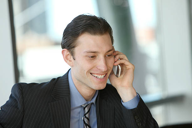 istock Young businessman talking on cell phone 96914846