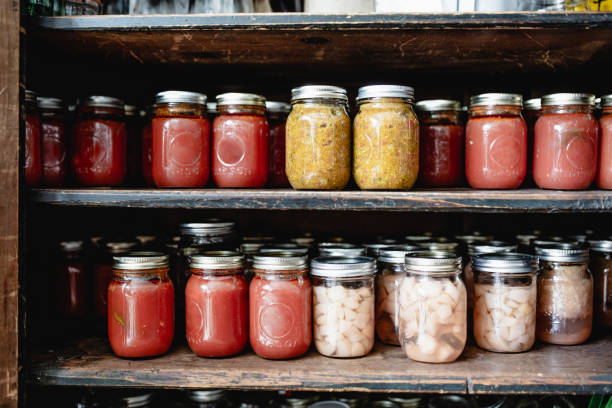 home canning fruit and vegetable  in storage shelves - fruit sauce imagens e fotografias de stock