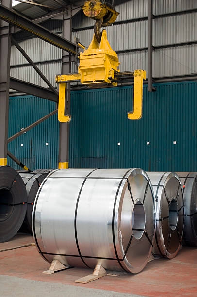 istock Wrapped & Unwrapped Steel Coils in Warehouse 96915428