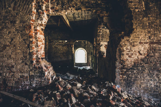 istock Ruined brick building inside, broken wall, dark creepy corridor view 969155432