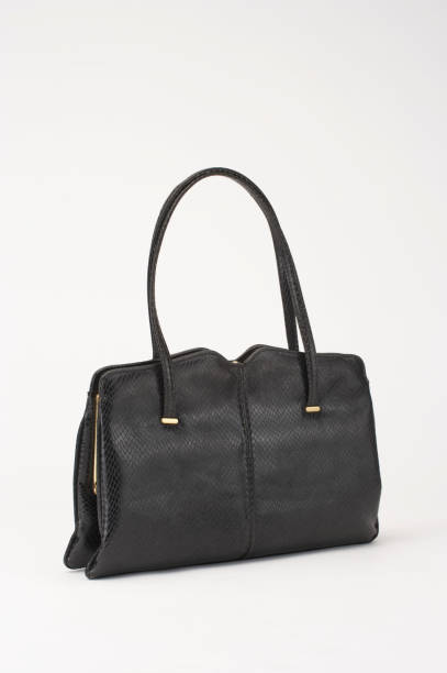 istock BLACK CROCODILE SKIN HANDBAG ISOLATED ON WHITE BACKGROUND 969156104