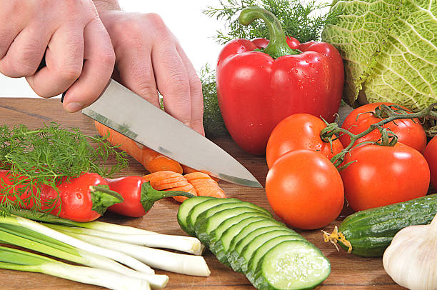 Hands cutting vegetables stock photo