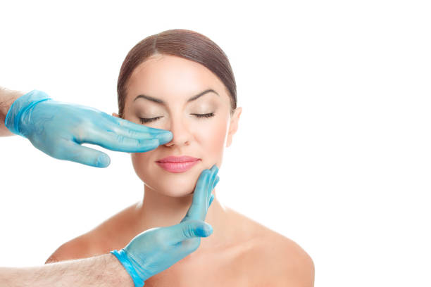 Woman is preparing for nose surgery, white background stock photo