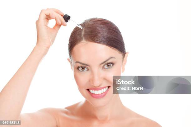 Woman Aplying Serum Essence Essential Oils To Her Hairline Stock Photo - Download Image Now