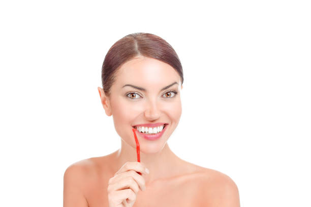 Happy woman holding interdental brush about to clean her teeth stock photo