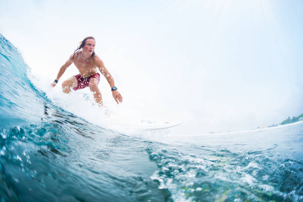 istock Young surfer rides an ocean tropical wave 969159650