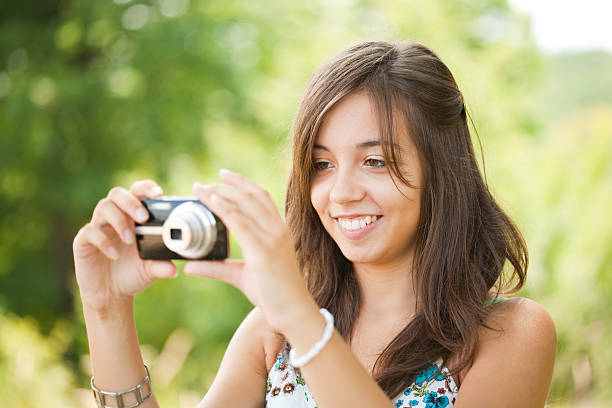 istock Young lady taking photos outdoors 96916144