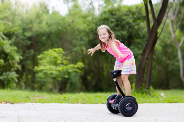 istock Child on hover board. Kids riding scooter 969175000