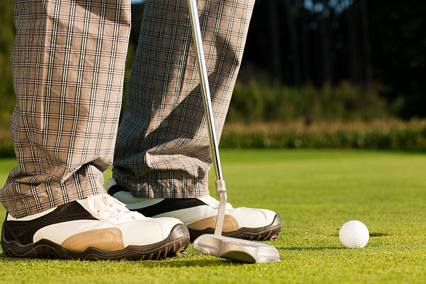 istock Golf player putting ball in hole 96918725