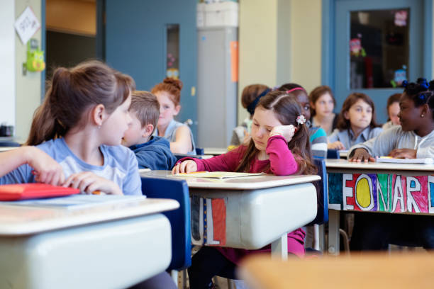 istock Multi-ethnic students sit into the class for the first day at school 969198772