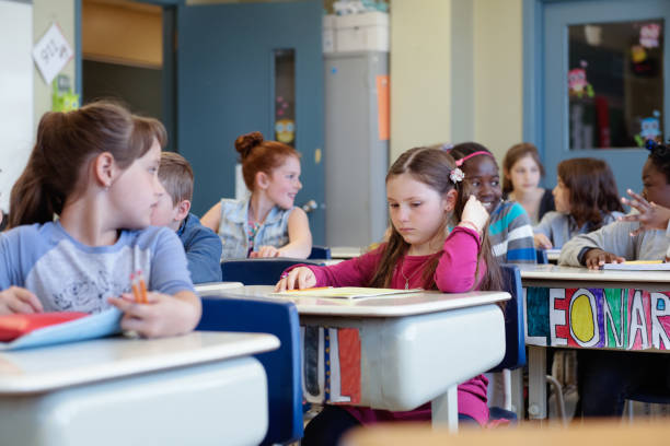 istock Multi-ethnic students sit into the class for the first day at school 969200796