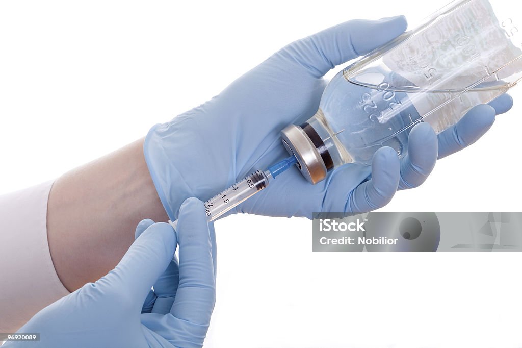 Medic filling the syringe with vaccine  Blue Stock Photo