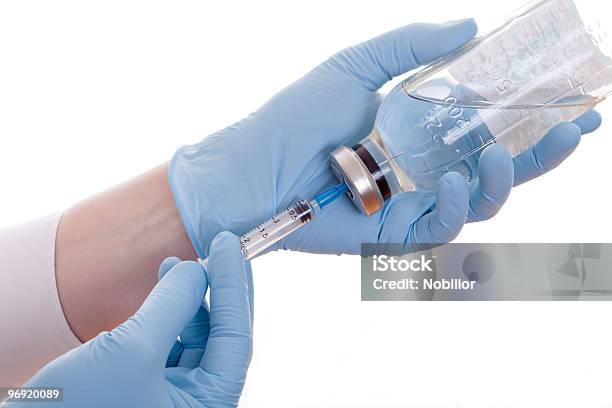 Medic Filling The Syringe With Vaccine Stock Photo - Download Image Now - Blue, Bottle, Color Image