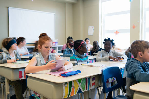 istock Multi-ethnic students sit into the class for the first day at school 969201086