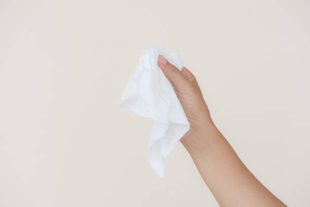 istock Woman hand holding or picking white tissue paper. 969203516
