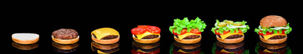 istock Process making of burger, step by step isolated on black background. Burger wide banner. Split burger. Burger divided in parts 969204334