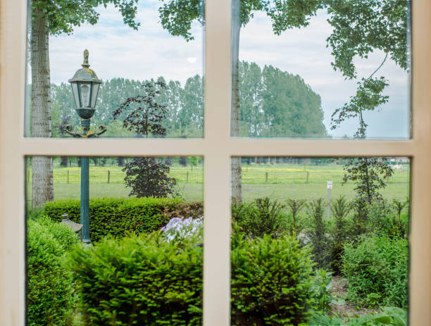istock Classic white cozy window with green landscape meadow view 969205740