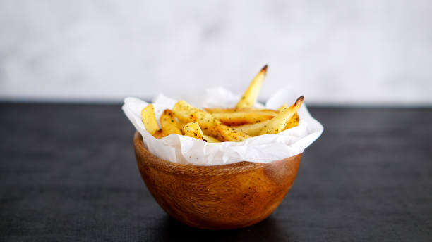 istock French fries on black background 969210798