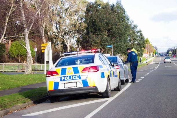 A Police officer pulls over a speeding driver on the main road of Bulls in New Zealand. stock photo