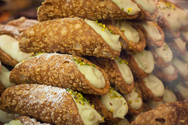 Sicilian pastry Canolli Sicilian pastry Canolli filled with pistachio and ricotta cream cannoli photos stock pictures, royalty-free photos & images