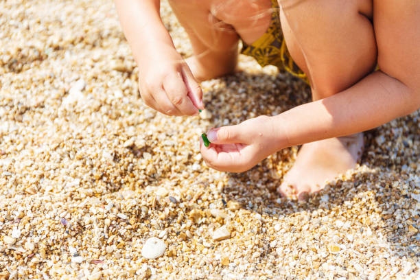istock Little boy collects pebbles 969220356