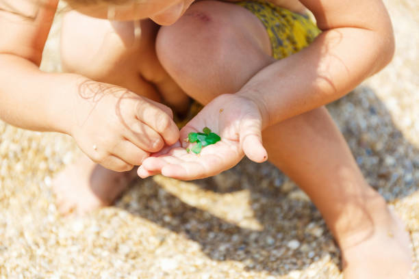 istock Green pebbles in a small palm 969220566