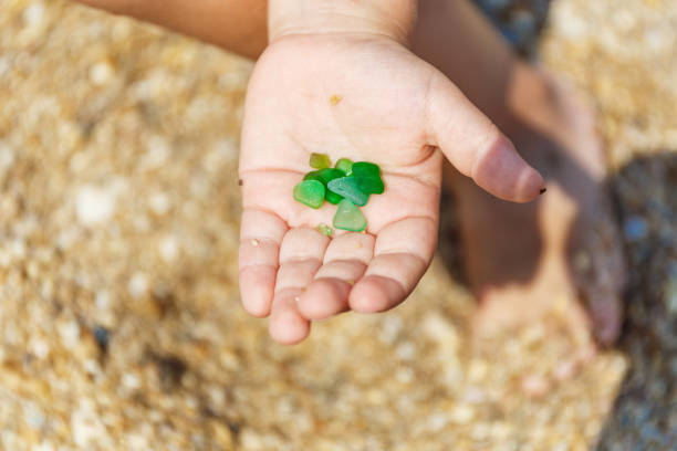 istock Green pebbles in a small palm 969222622