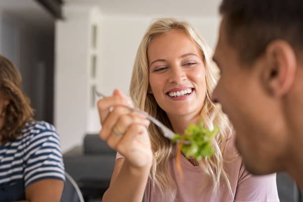 istock Smiling woman feeding her man 969231438