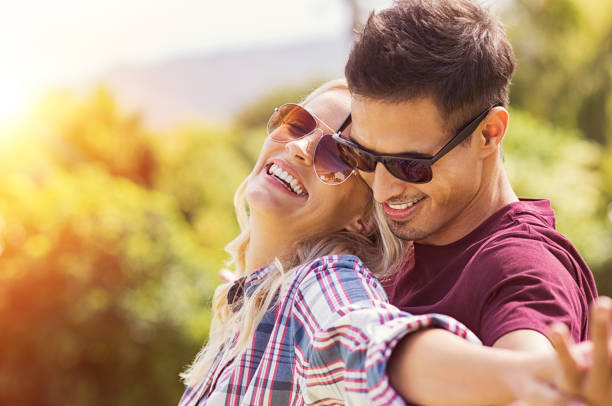 istock Romantic couple embracing at park 969231450