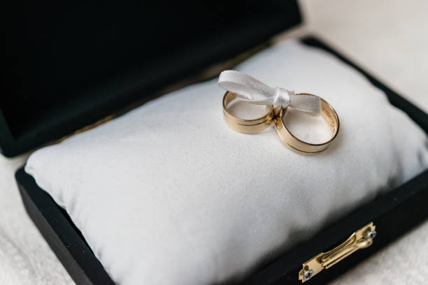 The priest blesses hands with the wedding rings of the bride and groom in the church.