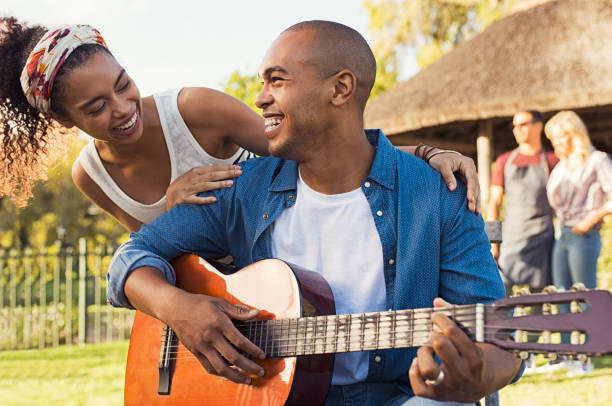 istock Happy man playing guitar outdoor 969231894
