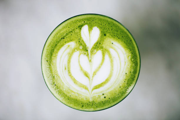 Green latte from above Trendy green latte, macro. Avocado or matcha foam with latte art. dragon fruit flower stock pictures, royalty-free photos & images