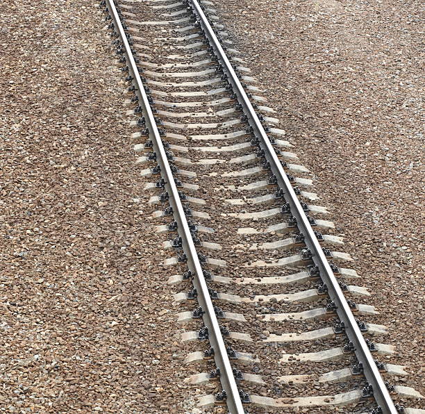 Railway track close up horizontally with wear and rust