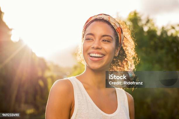 Young African Woman Smiling At Sunset Stock Photo - Download Image Now - Women, One Woman Only, Happiness