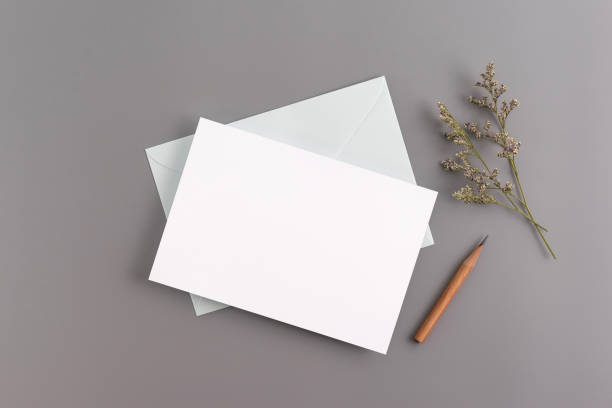 istock A wedding mock up concept. Wedding Invitation, envelopes, cards Papers on grey background with ribbon and decoration. Top view, flat lay, copy space 969234038