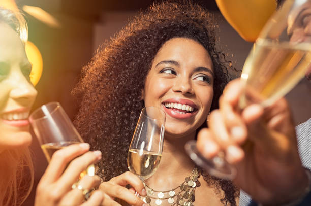 istock Happy woman drinking champagne at party 969234190