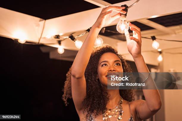 Woman Setting Up For Party Stock Photo - Download Image Now - Lighting Equipment, Illuminated, Light Bulb