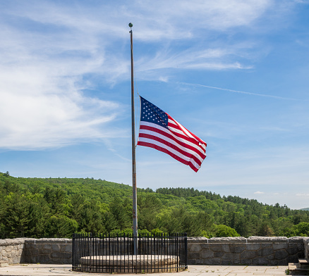 Horizontal image of an American flag at half staff