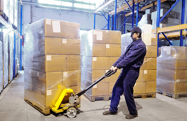 worker with hand pallet truck stacker at warehouse  stacker stock pictures, royalty-free photos & images