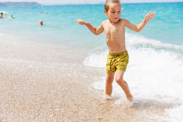 istock Beautiful boy and the sea 969243308