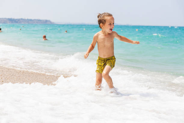 istock Beautiful boy and the sea 969243564