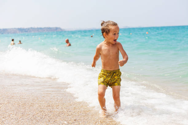 istock Beautiful boy and the sea 969245628