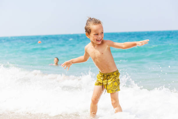 istock Beautiful boy and the sea 969248214