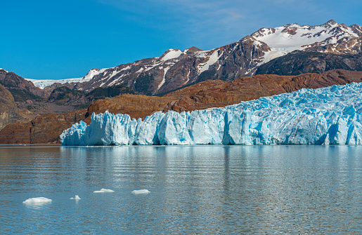 Landscape photograph of the Grey Glacier and Lago Grey with the Andes mountain range in the background, Torres del Paine national park, Puerto Natales, Patagonia, Chile.